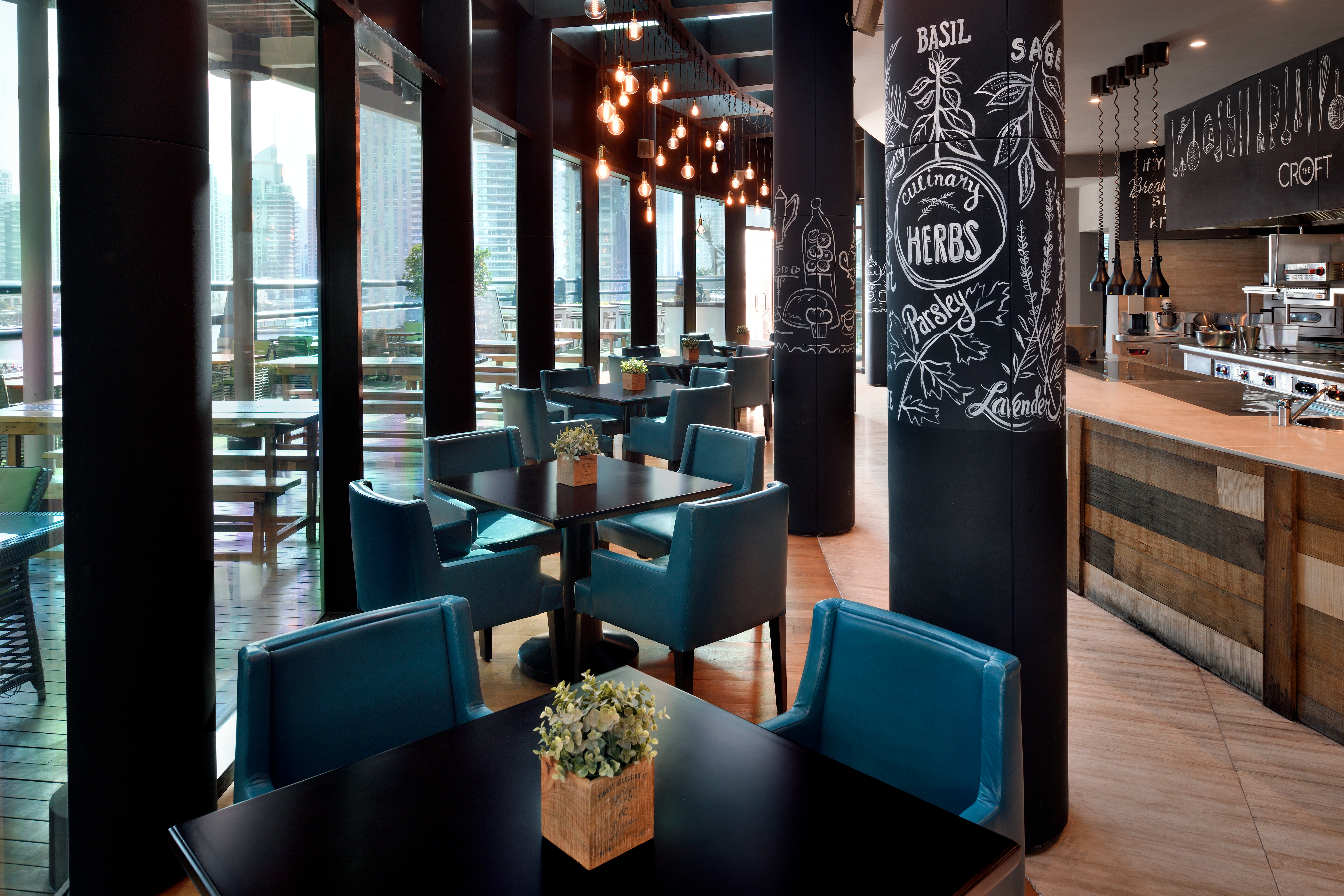 Blue chairs with chalkboard pillars and restaurant bar
