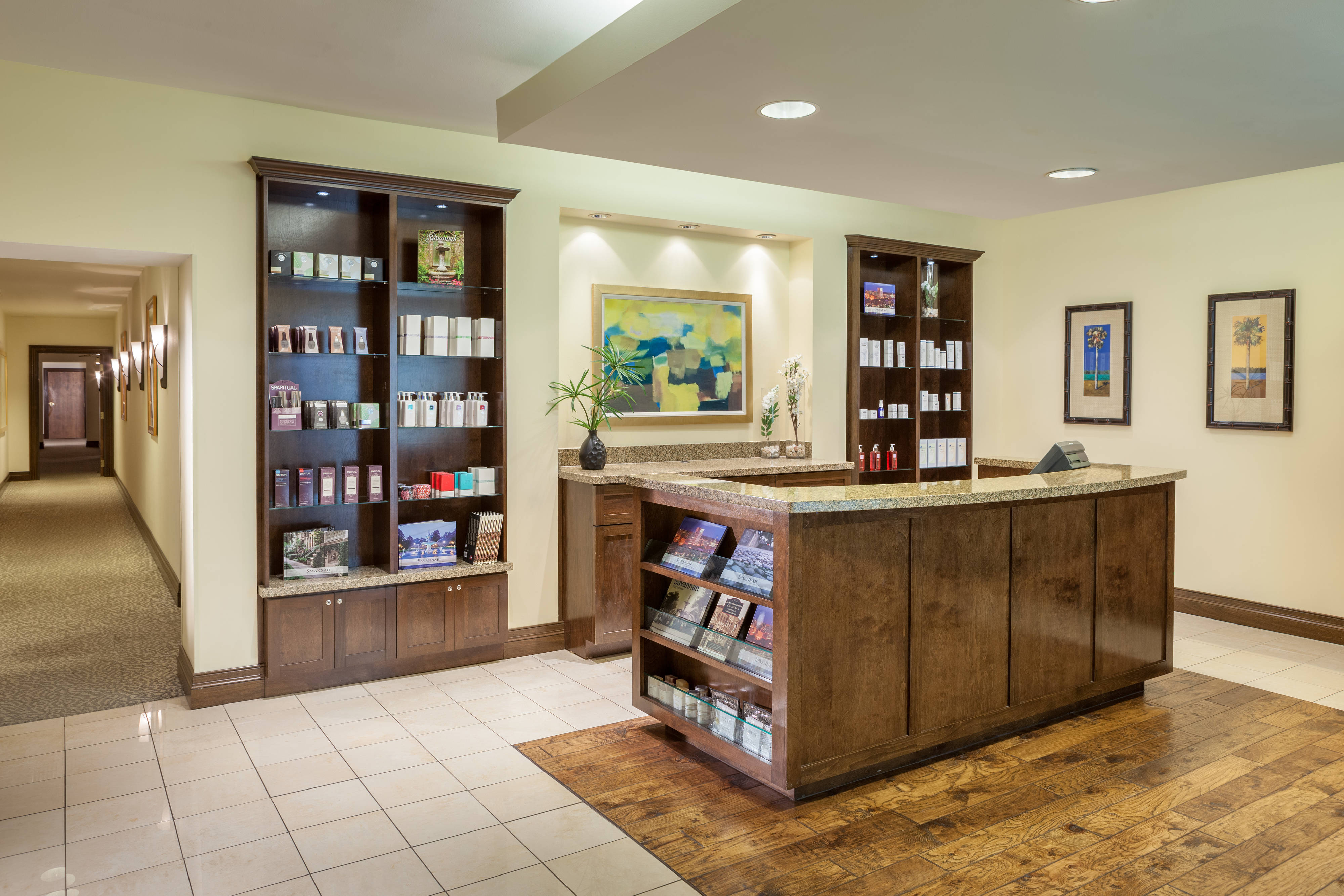 Magnolia Spa front desk with product displays on shelves and art on walls