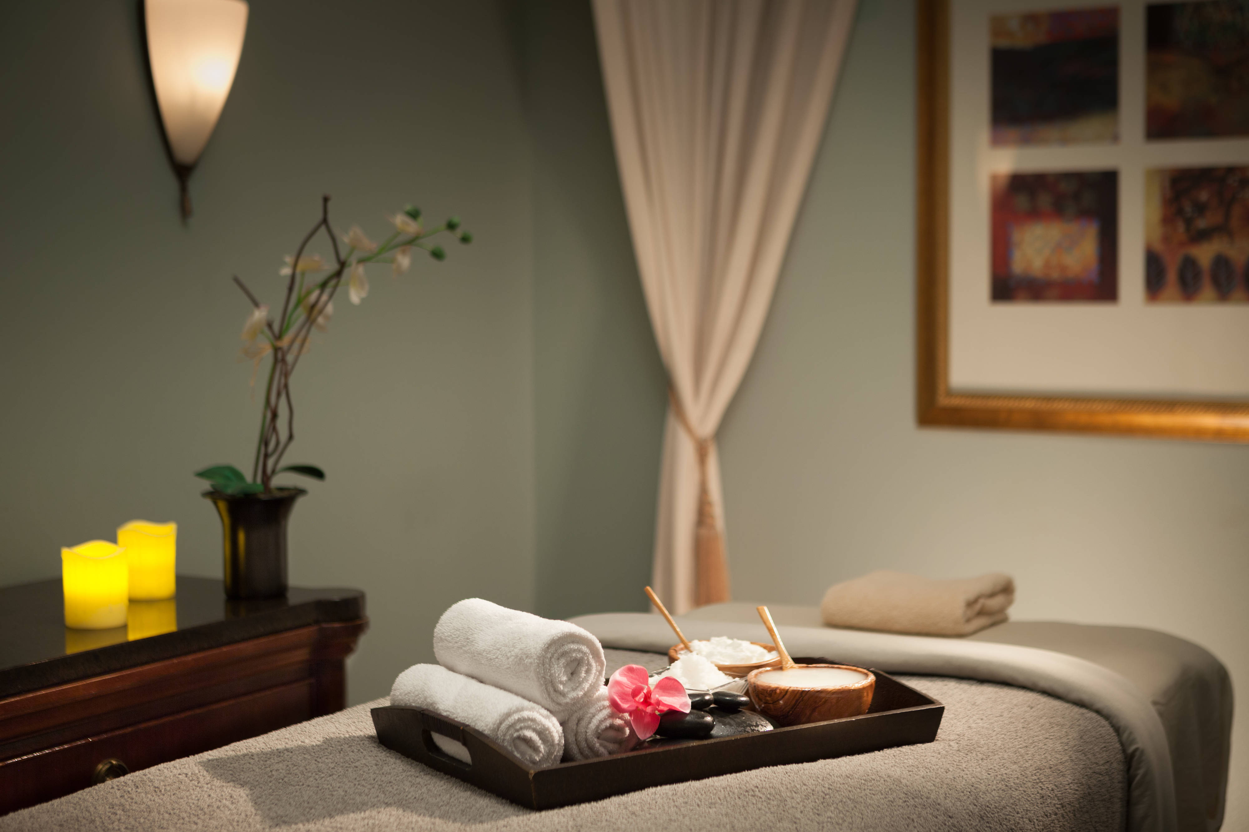 Spa treatment room with walls and treatment table linens in calm, neutral colors