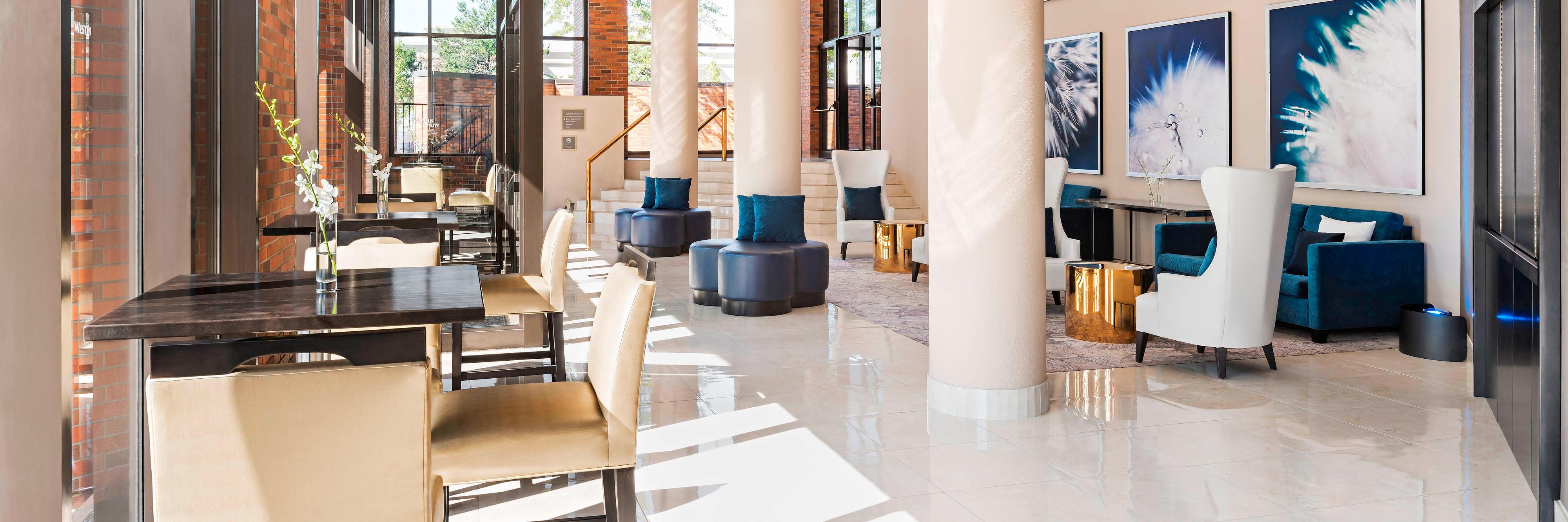 Seating area in large foyer with columns and natural light